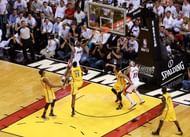 LeBron James #6 of the Miami Heat drives to the basket against Paul George in the 2013 ECF.